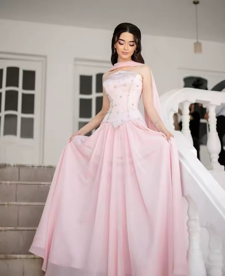 Light pink corset prom gown with floral embroidery and flowy A-line skirt worn in a bridal boutique – Maison Swan