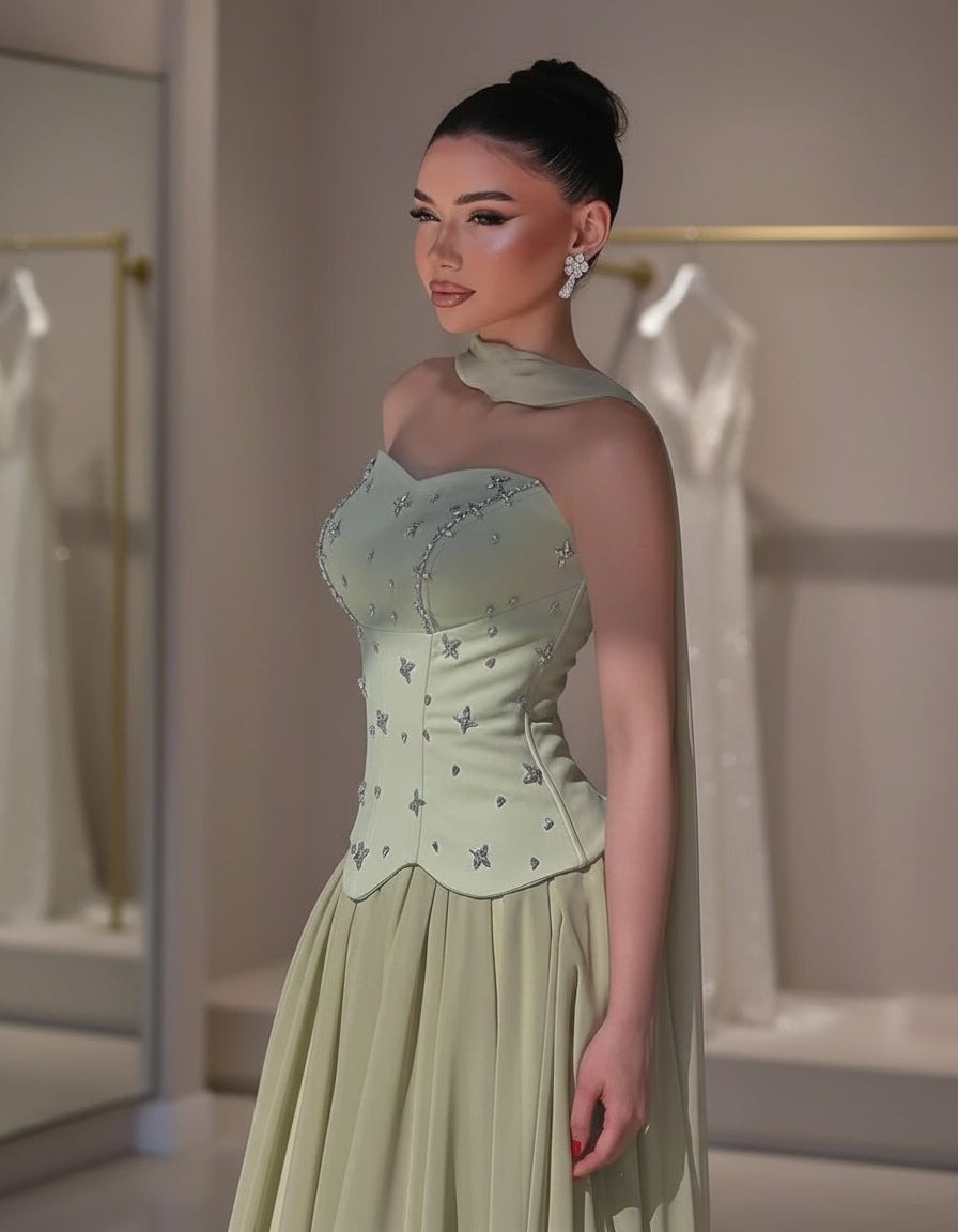 Light green corset prom gown with floral embroidery and flowy A-line skirt worn in a bridal boutique – Maison Swan