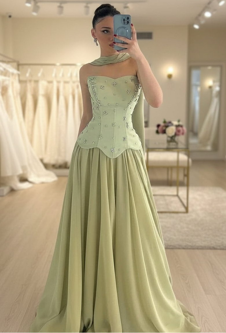 Light green corset prom gown with floral embroidery and flowy A-line skirt worn in a bridal boutique – Maison Swan
